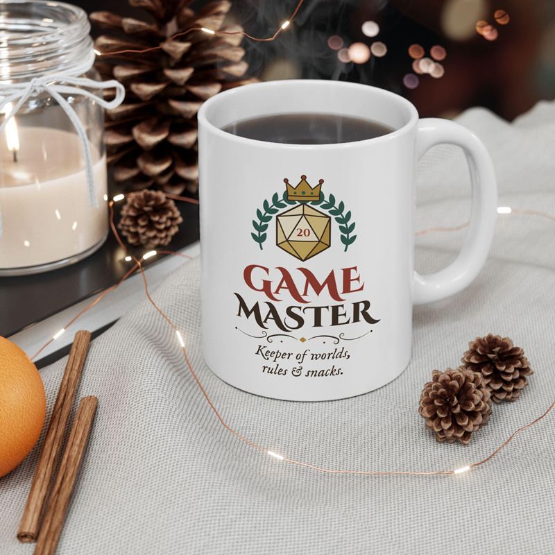 White mug printed with a crowned gold D20 in laurels and Game Master, Keeper of worlds, rules & snacks