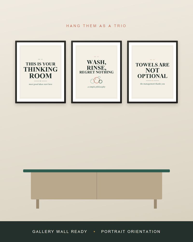 The bathroom prints framed in black as a row of three above a light wood sideboard