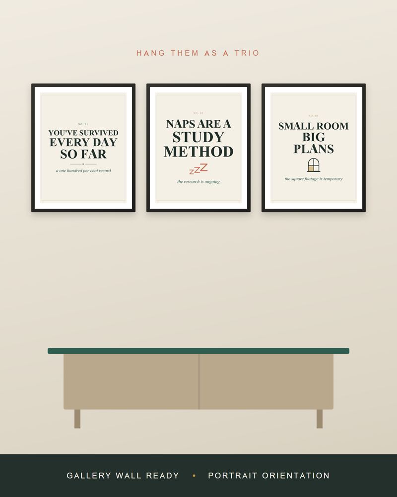 The dorm prints framed in black as a row of three above a light wood sideboard