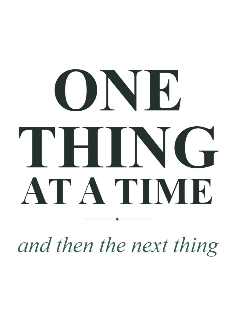 Mug design close-up: One Thing at a Time in dark serif capitals above the italic line and then the next thing