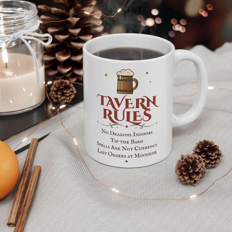 White mug printed with a wooden tankard, Tavern Rules and four rules such as No Dragons Indoors, beside pine cones